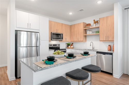Gourmet kitchens with granite countertops, islands, and subway tile backsplash and stainless steel appliances
