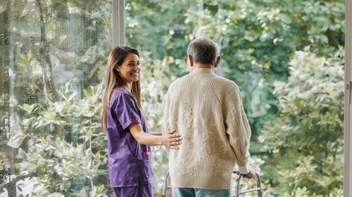 caregiver helping senior walk