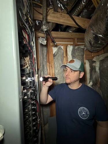 Inspecting an electrical panel during a home inspection
