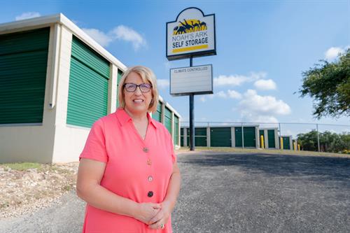 Owner in front of street sign