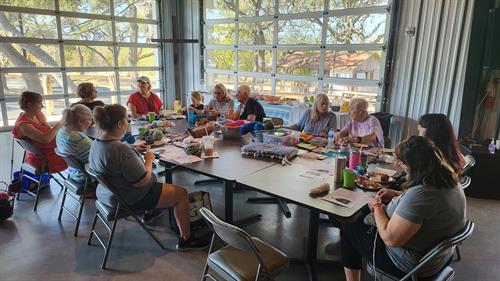 all ages come together to knit and serve