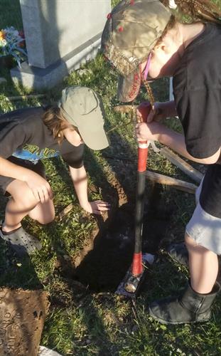 Compacting the new foundation for the grave marker