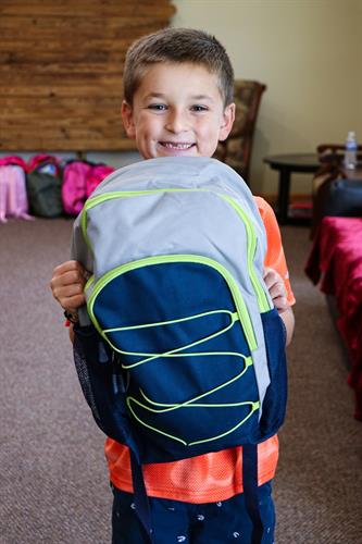 We do a backpack and school supply drive each summer. Jace was happy to help out!