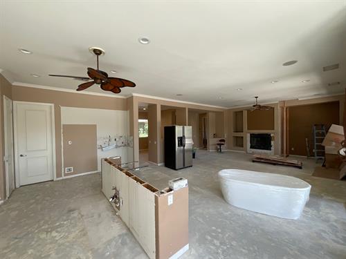 Construction management project check for remote home owner. Demo done, tub in kitchen.
