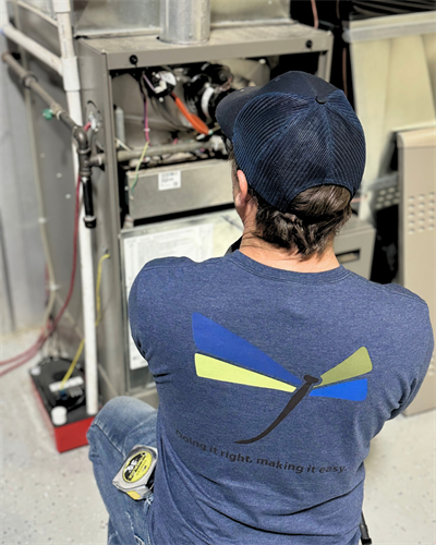 Hands-on furnace service. Our technician performs detailed component checks to ensure reliable winter heating.