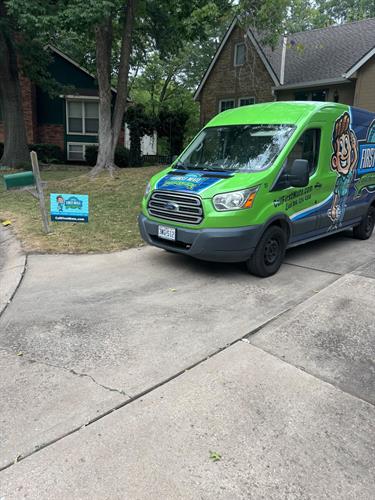 First Mate Heating & Cooling van and yard sign at a home in Blue Springs, MO.