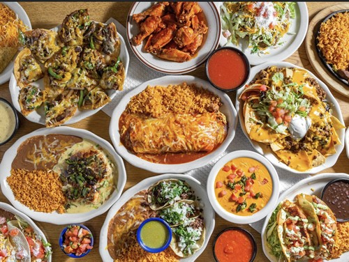 multiple dishes including cheese dip, nahcos and plaza burrito