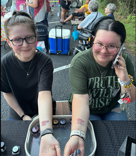 teens getting patriotic glitter tattoos