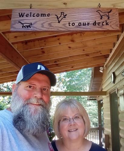 Marie & Rick with their custom made "Welcome to our Deck" sign