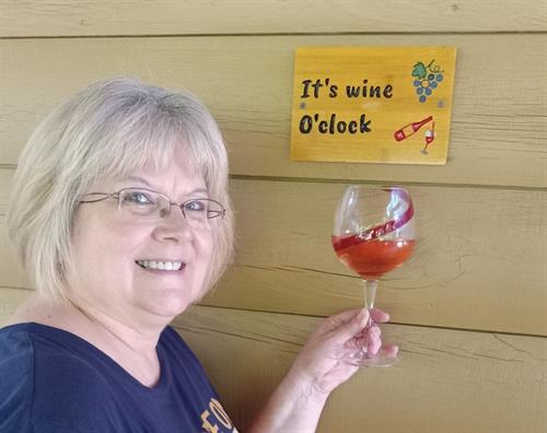 Marie with her wine O'clock sign. Cheers!