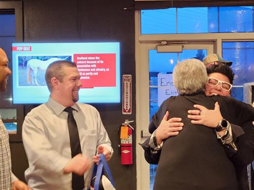 Ribbon Cutting Welcome Hug by Barbara, a Chamber Ambassador.
