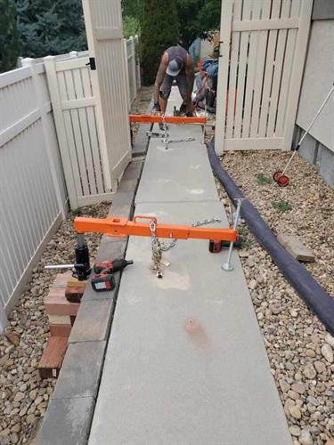 Lifting side walk back into place.