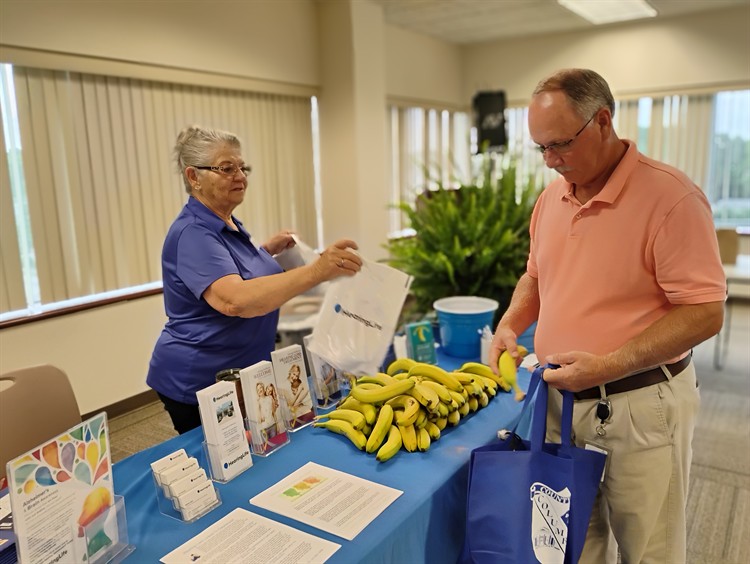 Gallery Image CC_Employee_Health_Fair_Glenda_giving_bag_jpg.jpg