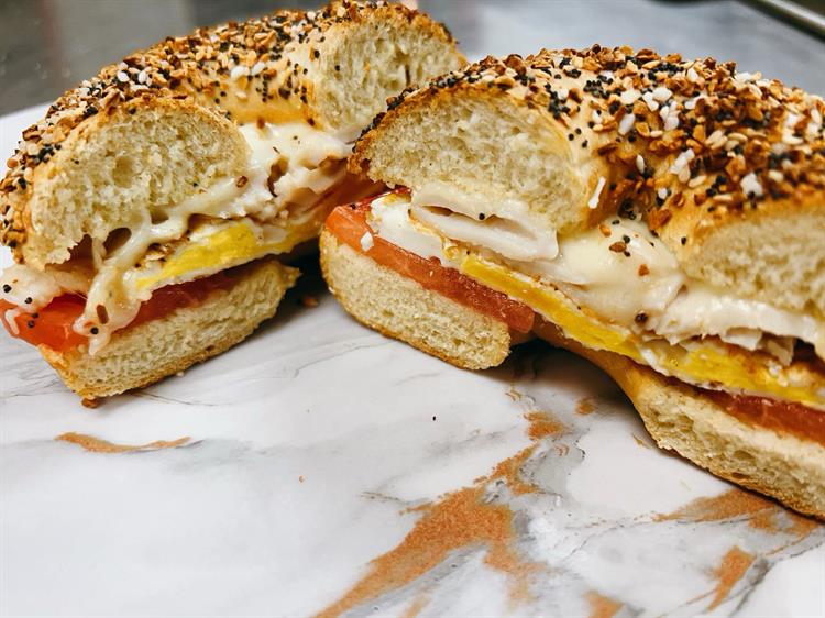 Turkey, egg, cheese, and tomato on an everything bagel