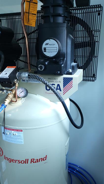 Air compressor wired with kelems grip for support of flexible cable
