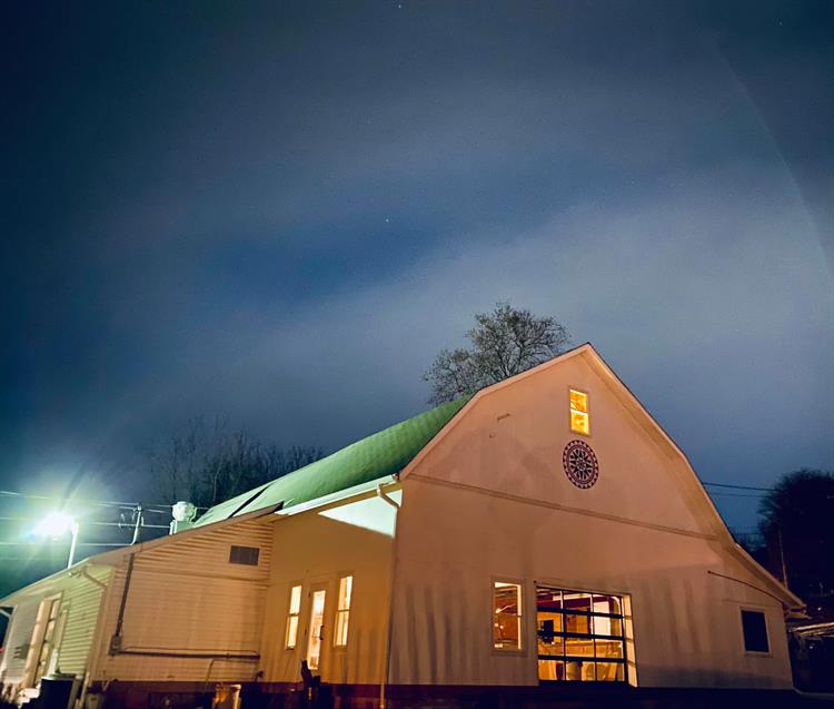 Outside of repurposed barn with exterior accent lighting