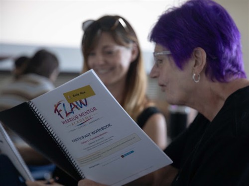 Founding Mentors Rebecca Chauffe, left, and Emi Rice review the Academy’s Participant Workbook
