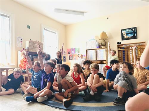 1st through 3rd grade students watch a science lesson.