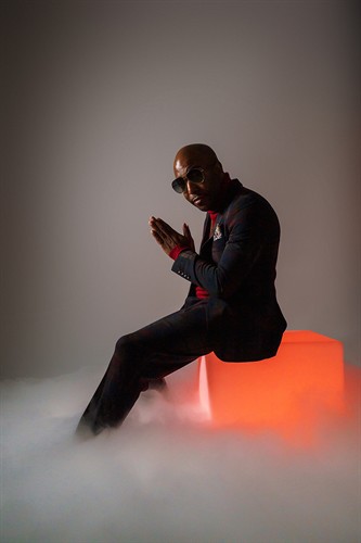 40th birthday studio portrait with low fog and a glowing orange box prop.