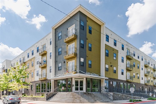 Exterior architectural photograph of a New Orleans apartment building.