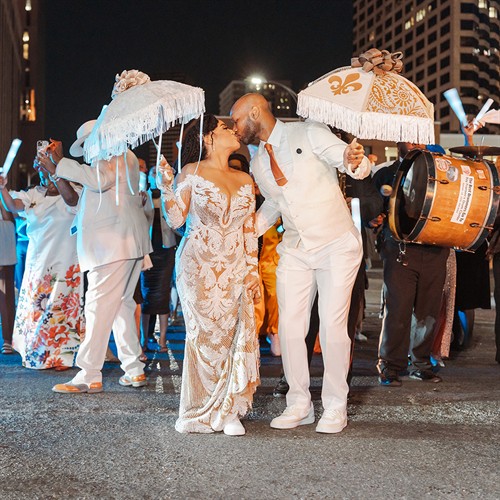 Chazz and La’Toya share a kiss during their Halloween wedding second line in New Orleans.