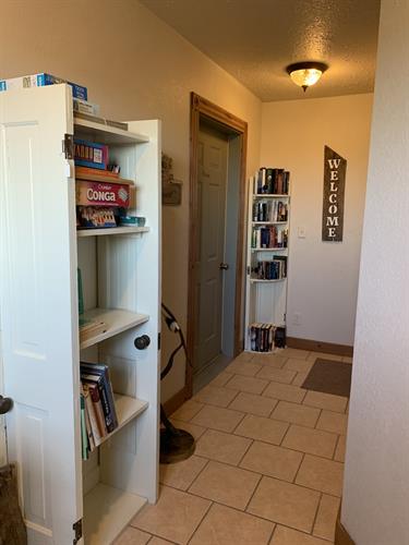 Hallway to the apartment offers games & books
