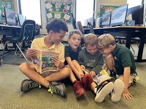 Students find inspiration in books and classmates before Technology class.