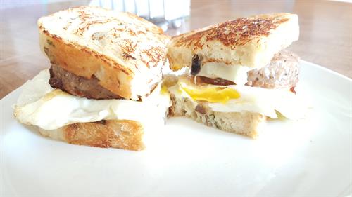 Barking Dog Breakfast Sandwhich: Two Sailer's Sausage Patties, Two Fried Eggs, Eau Galle Cheese Factory Pepper Jack Cheese all on Barking Dog Bakery's Potato Chive Sourdough.