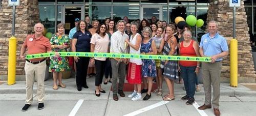 Supporting a local business' ribbon cutting