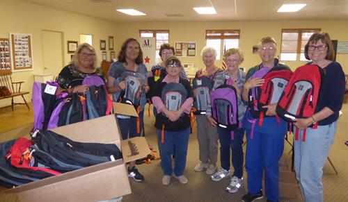Gallery Image 2021_08_06_ALSM_Backpack_stuffing_and_delivery._Mary_Ann_Lessin._Chair.jpg