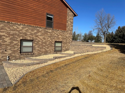 Lowry, MN project (pic 3 of 3) - Block retaining walls, landing steps, paver patio area, and landscaping.