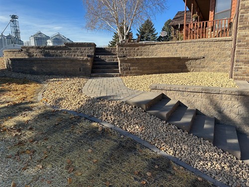 Lowry, MN project (pic 1 of 3) - Block retaining walls, landing steps, paver patio area, and landscaping.