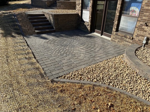 Lowry, MN project (pic 2 of 3) - Block retaining walls, landing steps, paver patio area, and landscaping.