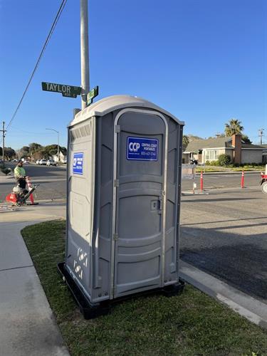 Construction restroom with containment tray