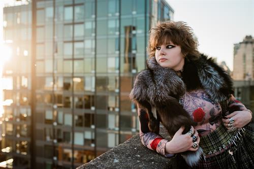 Photo of a punk rock girl at sunset on top of a parking garage in downtown Seattle by Katie Niemer Photography.