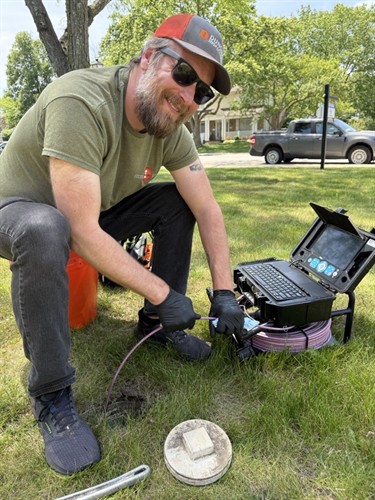 Prepping to access a clean out to examine a sewer line
