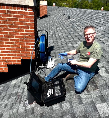 Accessing a clean out on the roof to examine a sewer line
