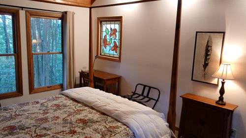 Queen Bedroom with 4 post bed & stainless glass window Queen Bedroom with 4 post bed & stainless glass window