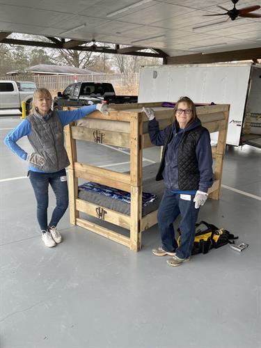 Two volunteers displaying a completed bunk!  Two more kids off the floor in our town!