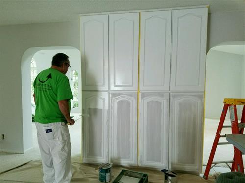 Changing outdated stained cabinets into solid white cabinets