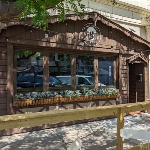 Taproom exterior: windows fully raise and there is a patio in the square!