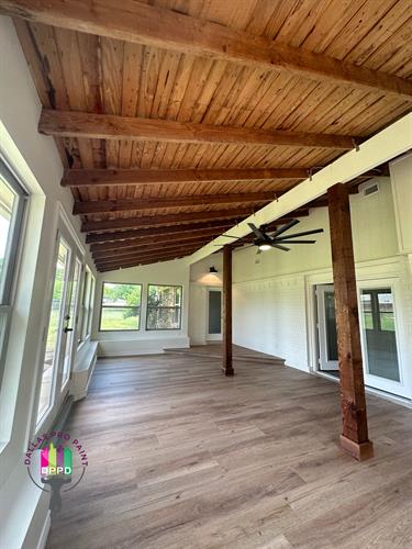 Sun Room - Raised ceiling to 12 ft, cedar beams to reinforce structure, new floors, weather proofing, new windows, paint, new doors, recess lighting