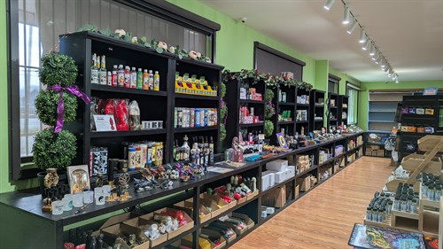 Retail space featuring candles, oils, incense, and spiritual tools