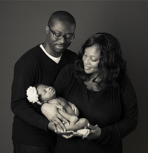 Newborn with family portrait at Camera Creations Photography studio.