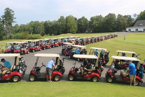 Golf Carts Lined Up for the Start of the 19th Hole Celebrating Life Every Day Tournament