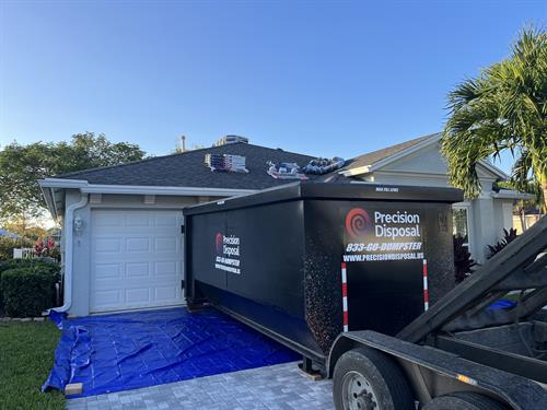 Paver driveway? No problem! Driveway protection with the dumpster delivered on wood and a tarp! We will protect your driveway!