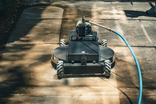 Commercial sidewalk and concrete cleaning using specialized ground-based equipment.