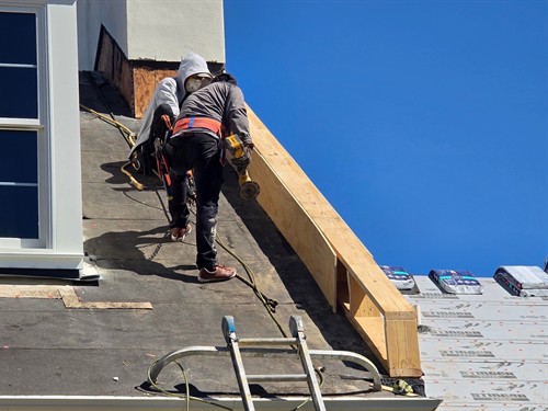 Roof repairs and structural wood restoration as part of commercial property maintenance.