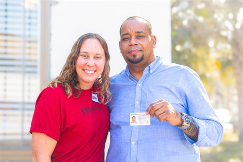 An IDignity team member poses with an IDignity client, who came back to IDignity to change his address on his ID after receiving housing! 