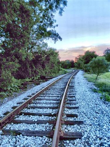 Railroad tracks wind into summer sunset near downtown Ocoee